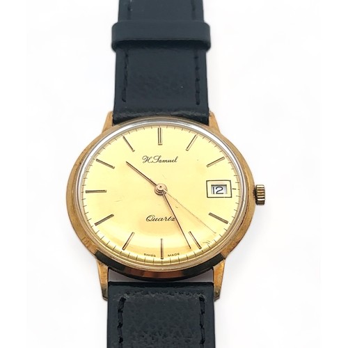 96 - A H. Samuel 9ct gold gents wristwatch. Gold toned dial with baton hour markers and date display. Ins... 