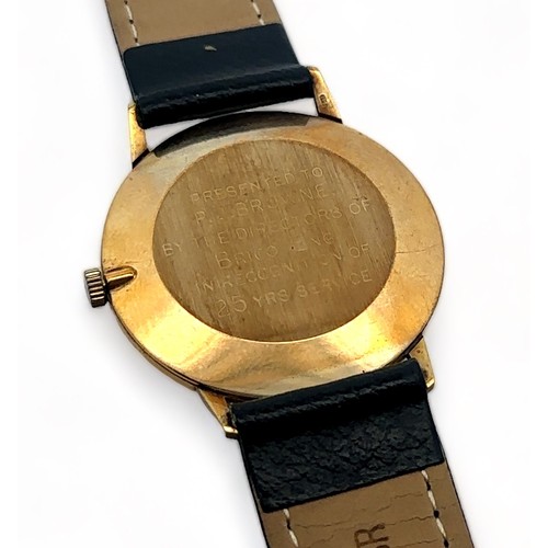 96 - A H. Samuel 9ct gold gents wristwatch. Gold toned dial with baton hour markers and date display. Ins... 