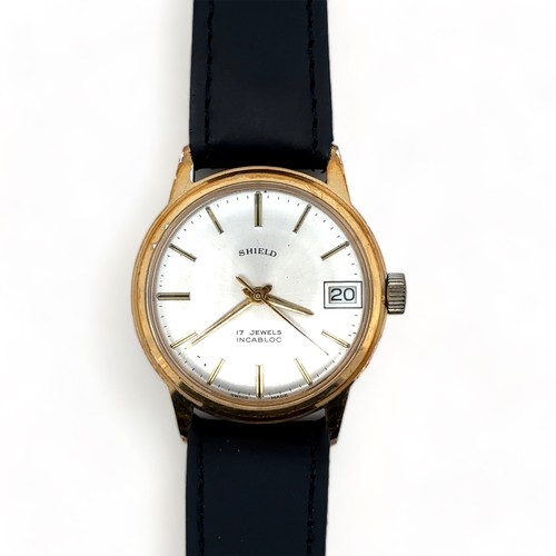 115 - A 1960s Shield 17 jewel manual date watch with gold plated case, silver dial and baton hour markers ... 