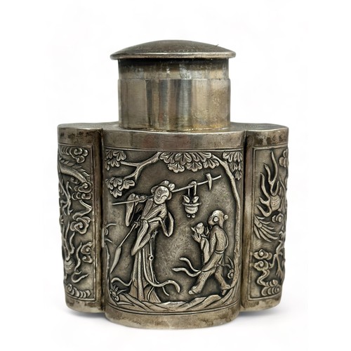 180 - A Chinese export silver tea caddy in a quatrefoil form with lid, decorated with repousse scenes of f... 