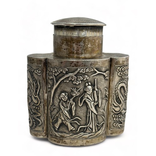 180 - A Chinese export silver tea caddy in a quatrefoil form with lid, decorated with repousse scenes of f... 