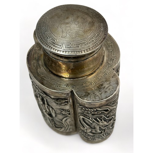 180 - A Chinese export silver tea caddy in a quatrefoil form with lid, decorated with repousse scenes of f... 