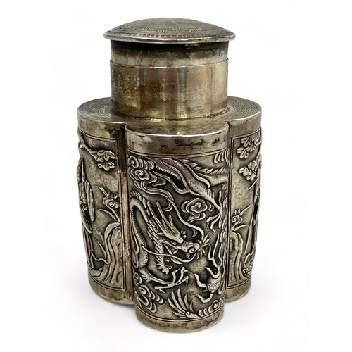 180 - A Chinese export silver tea caddy in a quatrefoil form with lid, decorated with repousse scenes of f... 