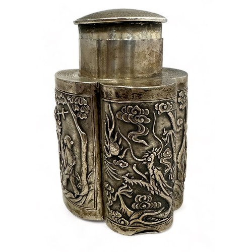 180 - A Chinese export silver tea caddy in a quatrefoil form with lid, decorated with repousse scenes of f... 