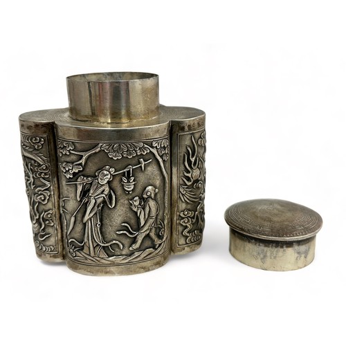 180 - A Chinese export silver tea caddy in a quatrefoil form with lid, decorated with repousse scenes of f... 