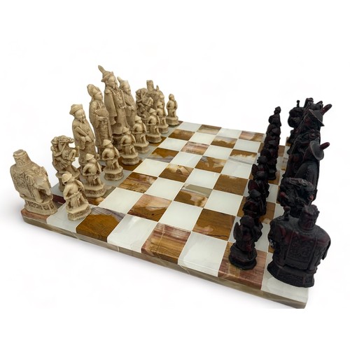 241 - A marble chess board together with a set of resin Chinese style chess figures. Some of the resin fig... 