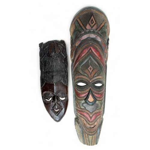 337 - Pair of decorative wooden tribal masks, two designs, one larger and hand painted. Heights 75cm & 48c... 