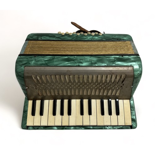 371 - A Hohner Mignon II Accordion. Turquoise. Appears to be playing.