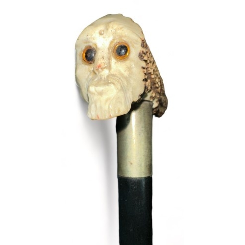 338 - Ebonised walking Stick with antler handle depicting a skeletal head on one end of the handle. Stick ... 