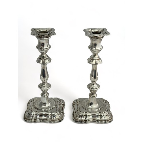 173 - A pair of mid 18th Century English style silver candlesticks with detachable sconces. By Fordham & F... 