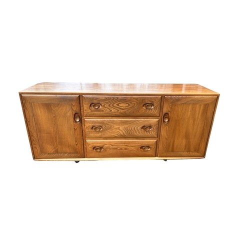 434 - Ercol - mid-20th century elm 'Windsor' sideboard fitted with three drawers flanked by two cupboards,... 