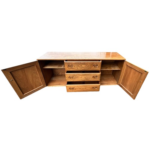 434 - Ercol - mid-20th century elm 'Windsor' sideboard fitted with three drawers flanked by two cupboards,... 