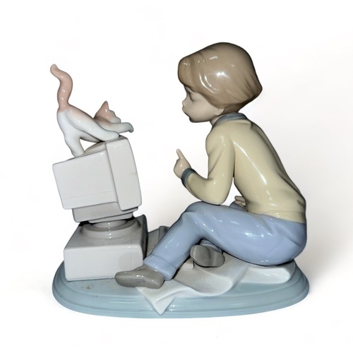 257 - Lladro, 6693 ‘ Programming Pals ‘ porcelain figure – modelled as a boy seated at a computer with a k... 