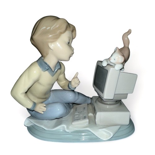 257 - Lladro, 6693 ‘ Programming Pals ‘ porcelain figure – modelled as a boy seated at a computer with a k... 