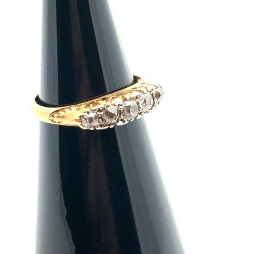 53 - Five stone old cut diamond ring in unmarked yellow metal scroll mount, size I. Estimated diamond wei... 