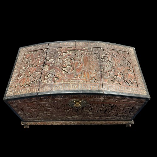 455 - A Chinese Carved Camphorwood Coffer. With curved lid. Made in Hong Kong. Provenance of being used on... 