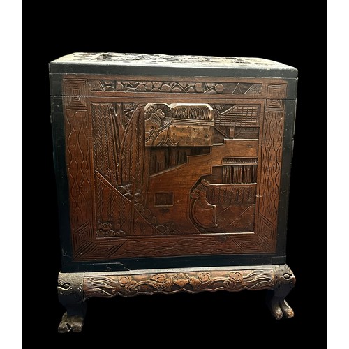 455 - A Chinese Carved Camphorwood Coffer. With curved lid. Made in Hong Kong. Provenance of being used on... 