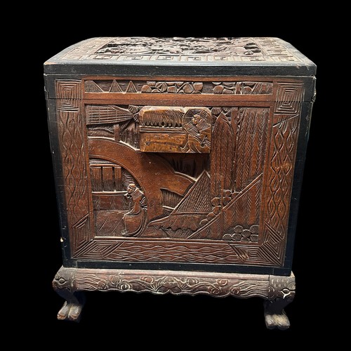 455 - A Chinese Carved Camphorwood Coffer. With curved lid. Made in Hong Kong. Provenance of being used on... 