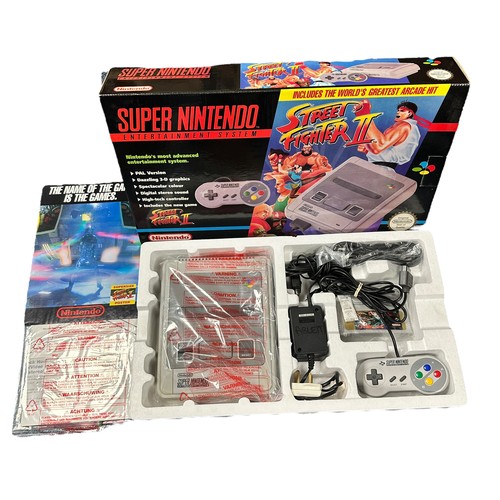 355A - A boxed PAL version of the Street Fighter 2 SNES Super Nintendo Console, complete with the iconic St... 