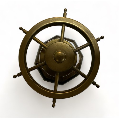 109 - Brass Ships Wheel in the form of a nutcracker mounted on a wooden stand. Working order.