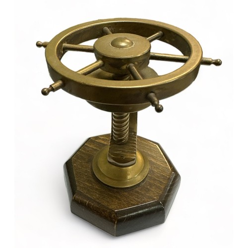 109 - Brass Ships Wheel in the form of a nutcracker mounted on a wooden stand. Working order.