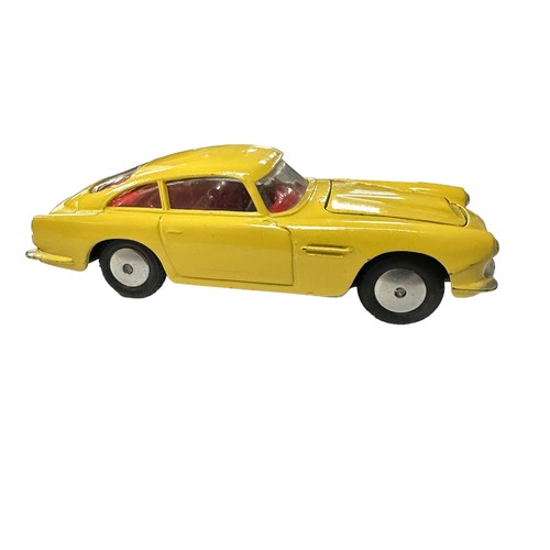 119 - Corgi Aston Martin DB4 yellow with red interior and flat hubs No. 218, generally excellent in good p... 