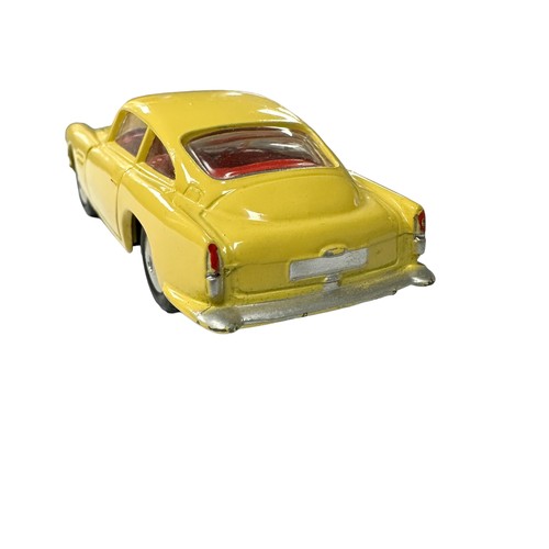 119 - Corgi Aston Martin DB4 yellow with red interior and flat hubs No. 218, generally excellent in good p... 