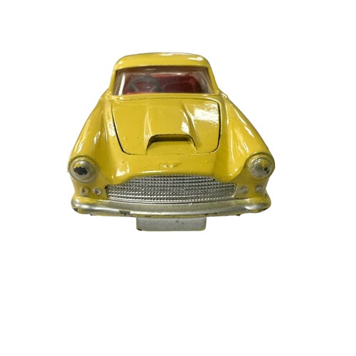 119 - Corgi Aston Martin DB4 yellow with red interior and flat hubs No. 218, generally excellent in good p... 