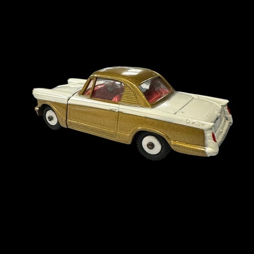 132 - Corgi Triumph Herald Coupe metallic gold and white with red interior No. 231, generally excellent in... 