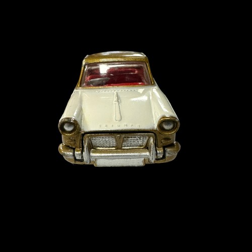 132 - Corgi Triumph Herald Coupe metallic gold and white with red interior No. 231, generally excellent in... 