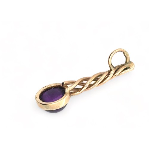 41 - An amethyst cabochon pendant set in unmarked yellow metal (tests as 9ct using XRF). Pendant length 3... 