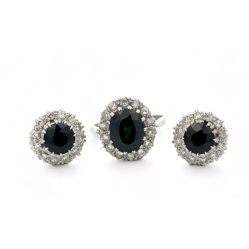 47 - A dark green sapphire and diamond ring and matching earrings.  Unmarked metal tests as 18ct white go... 