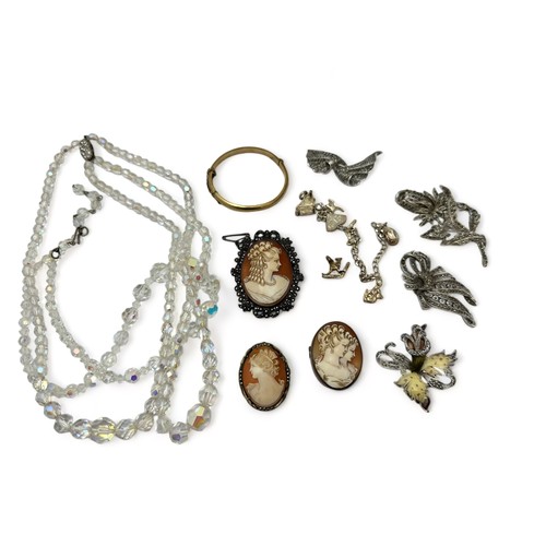 64 - Assortment of silver and costume jewellery items including three cameo brooches, a charm bracelet st... 