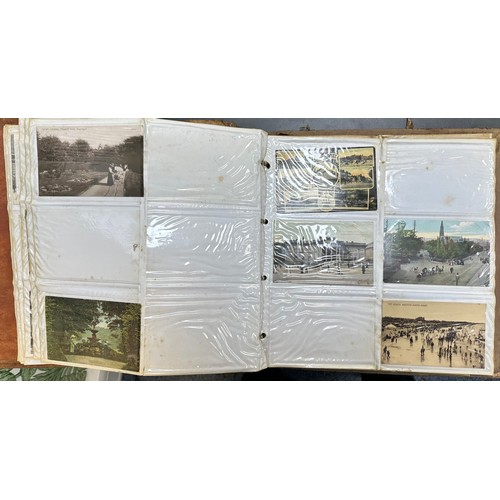 409 - An early to mid 20th Century range of postcards (198) in an an album, in mixed condition, with stree... 