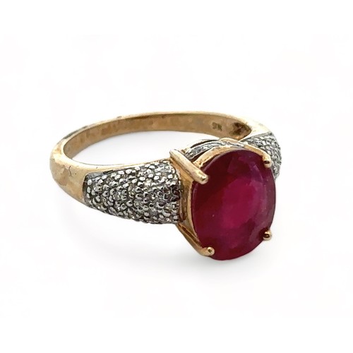 22 - A 9ct yellow gold ring set with a central ruby and diamond shoulders. Size N. Weight 3.8g. In excell... 