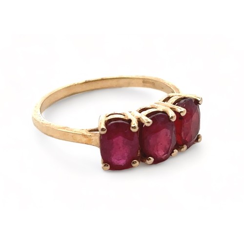 14 - A three stone ruby ring in 9ct yellow gold. Size S. In very good condition.

Please see the buyer's ... 