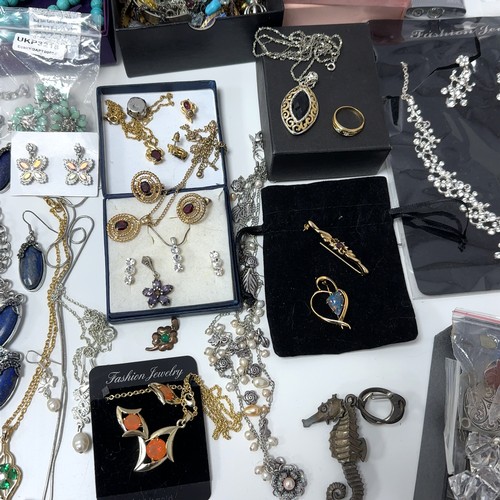 51 - Large quantity of costume and silver jewellery. Includes a silver and ruby necklace, silver pendants... 