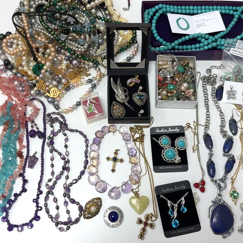 51 - Large quantity of costume and silver jewellery. Includes a silver and ruby necklace, silver pendants... 