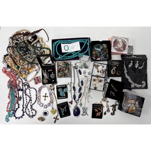 51 - Large quantity of costume and silver jewellery. Includes a silver and ruby necklace, silver pendants... 