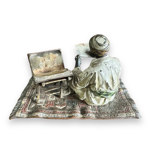 384 - Franz Bergman (Austrian, 1861-1936), late 19th century, cast as an Arab scribe seated on a carpet, t... 