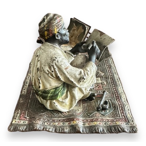 384 - Franz Bergman (Austrian, 1861-1936), late 19th century, cast as an Arab scribe seated on a carpet, t... 