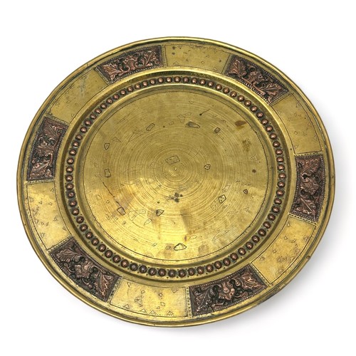 254 - A brass and copper Arts and Crafts style plate. Diameter 29.cm approx.