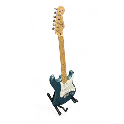 205 - Fender Player Stratocaster in a blue gloss finish. Still has protective film on the pickguard, which... 