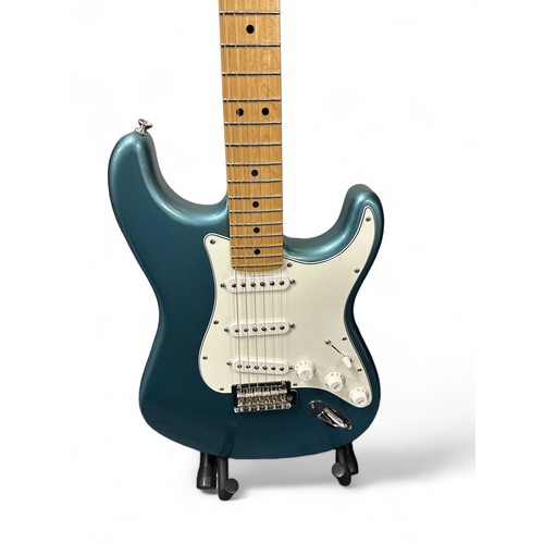 205 - Fender Player Stratocaster in a blue gloss finish. Still has protective film on the pickguard, which... 