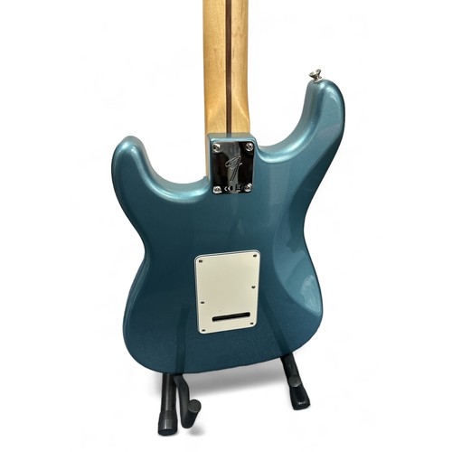 205 - Fender Player Stratocaster in a blue gloss finish. Still has protective film on the pickguard, which... 