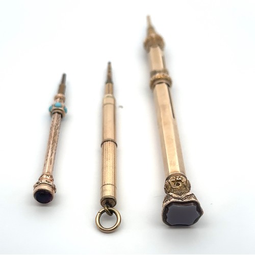 172 - Three propelling pencils: Includes an unmarked 9ct gold pencil with agate termination, 11cm in lengt... 