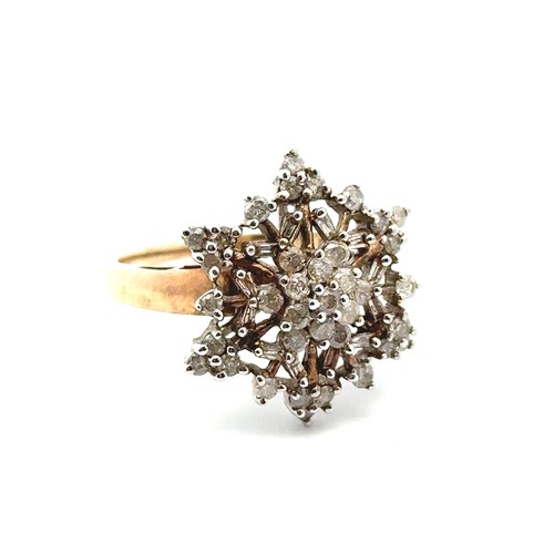 35 - A 9ct gold and diamond ring with round and tapered baguette diamonds set in a snowflake design. Size... 