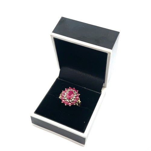 12 - A ruby and diamond 9ct gold cluster ring, size J. Weight 3.74g.

Please see the buyer's terms and co... 