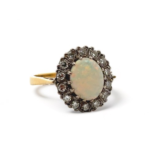 36 - An 18ct yellow gold, opal and diamond ring. Opal (approx 9mm x 6mm) with full spectrum of colour sur... 