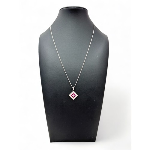 20 - A ruby and diamond 18ct white gold pendant necklace. Hallmarks to pendant and 18